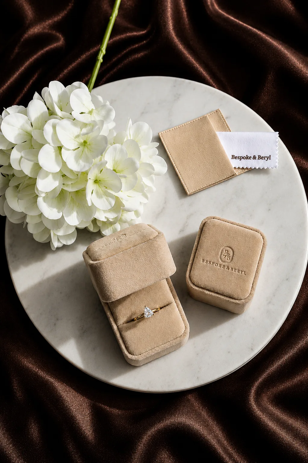 Bespoke & Beryl engagement ring in branded ring box with hydrangeas